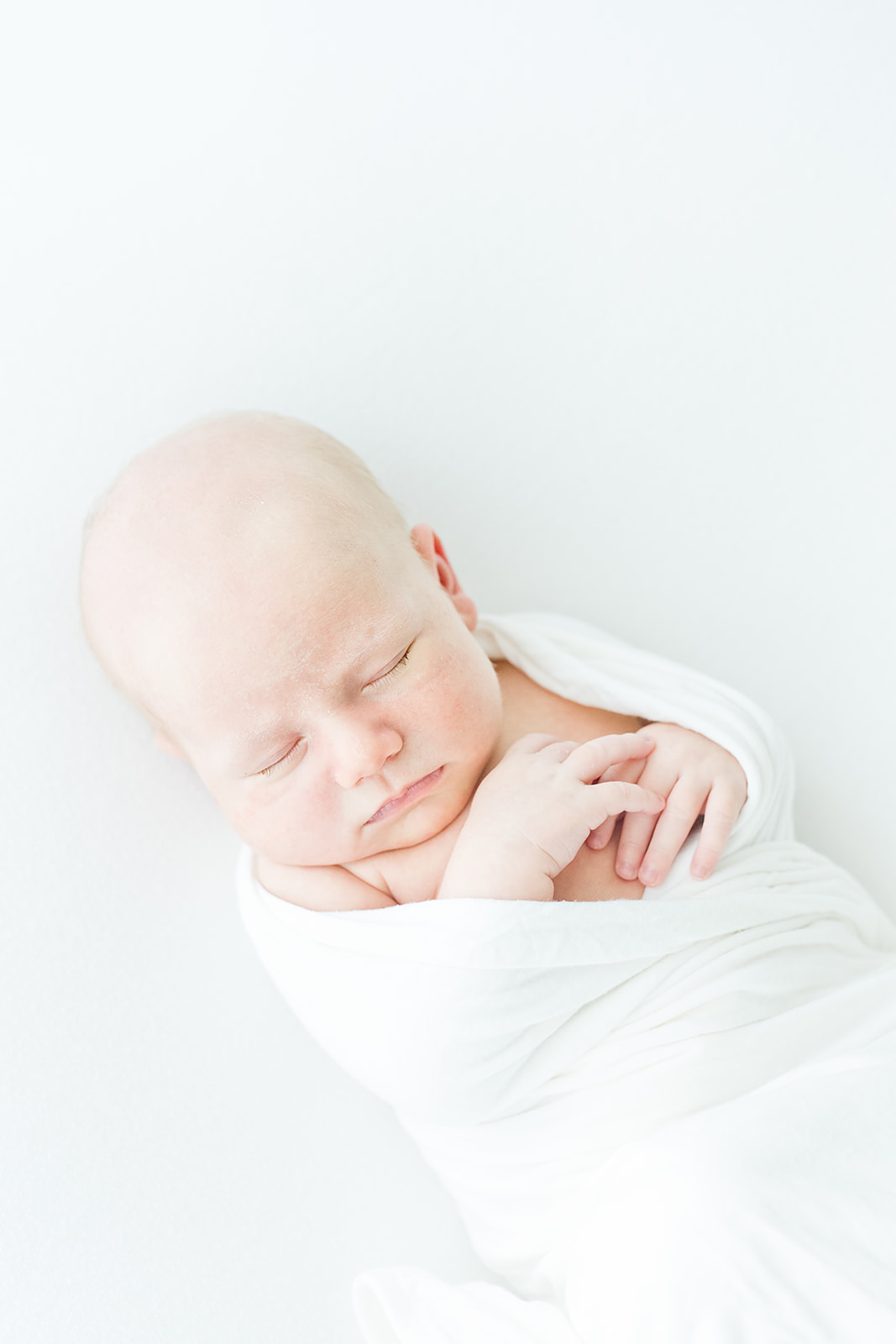 newborn baby photography by amanda mcquade in charlotte studio with white wrap